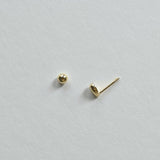 Close-up showing screwball back of 14K teardrop cartilage earring