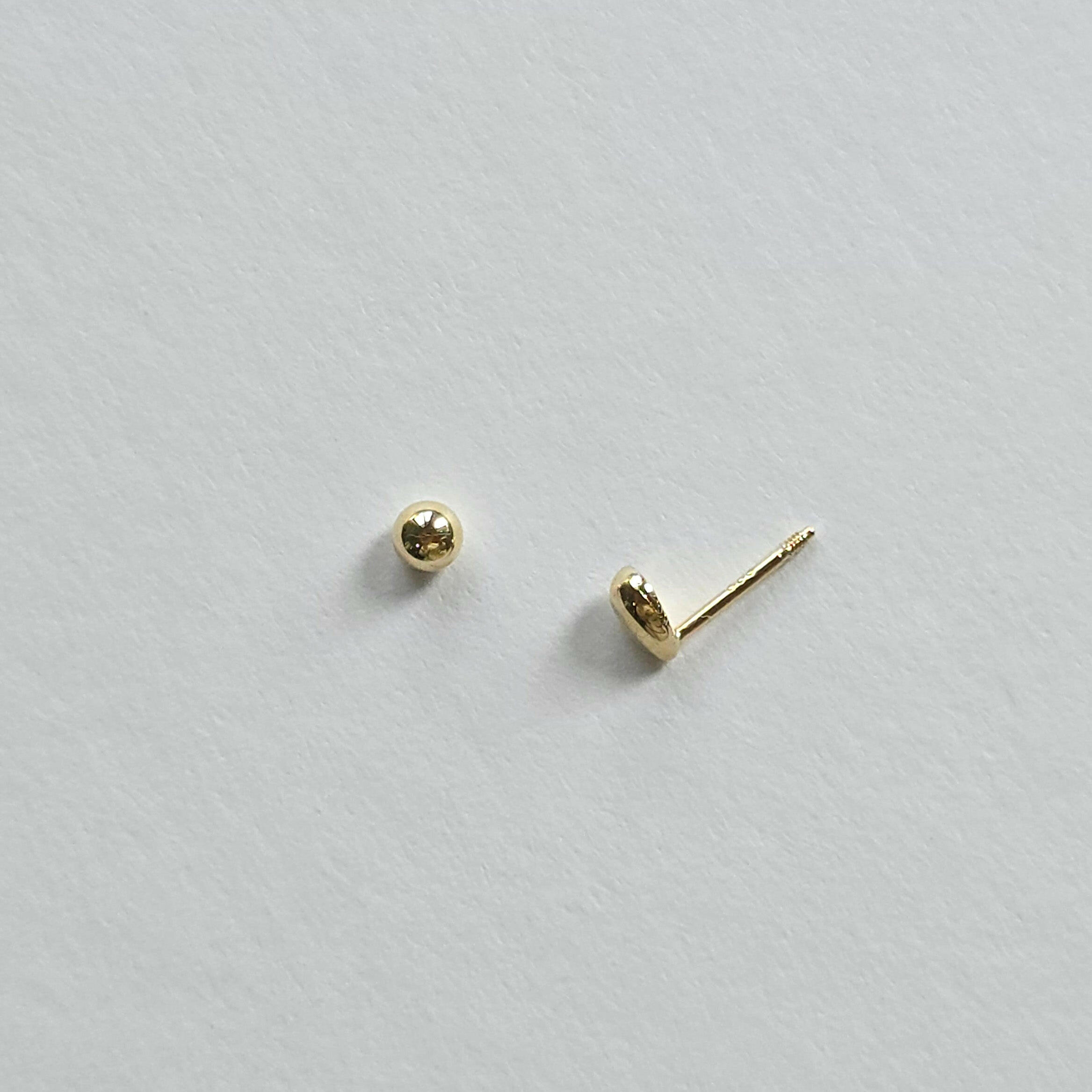 Close-up showing screwball back of 14K teardrop cartilage earring