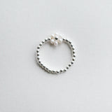 Delicate flower-shaped pearl ring with silver beads, elegant pearl jewelry perfect for formal occasions
