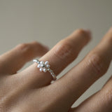 Delicate flower-shaped pearl ring with silver beads, elegant pearl jewelry perfect for formal occasions