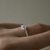 Delicate flower-shaped pearl ring with silver beads, elegant pearl jewelry perfect for formal occasions