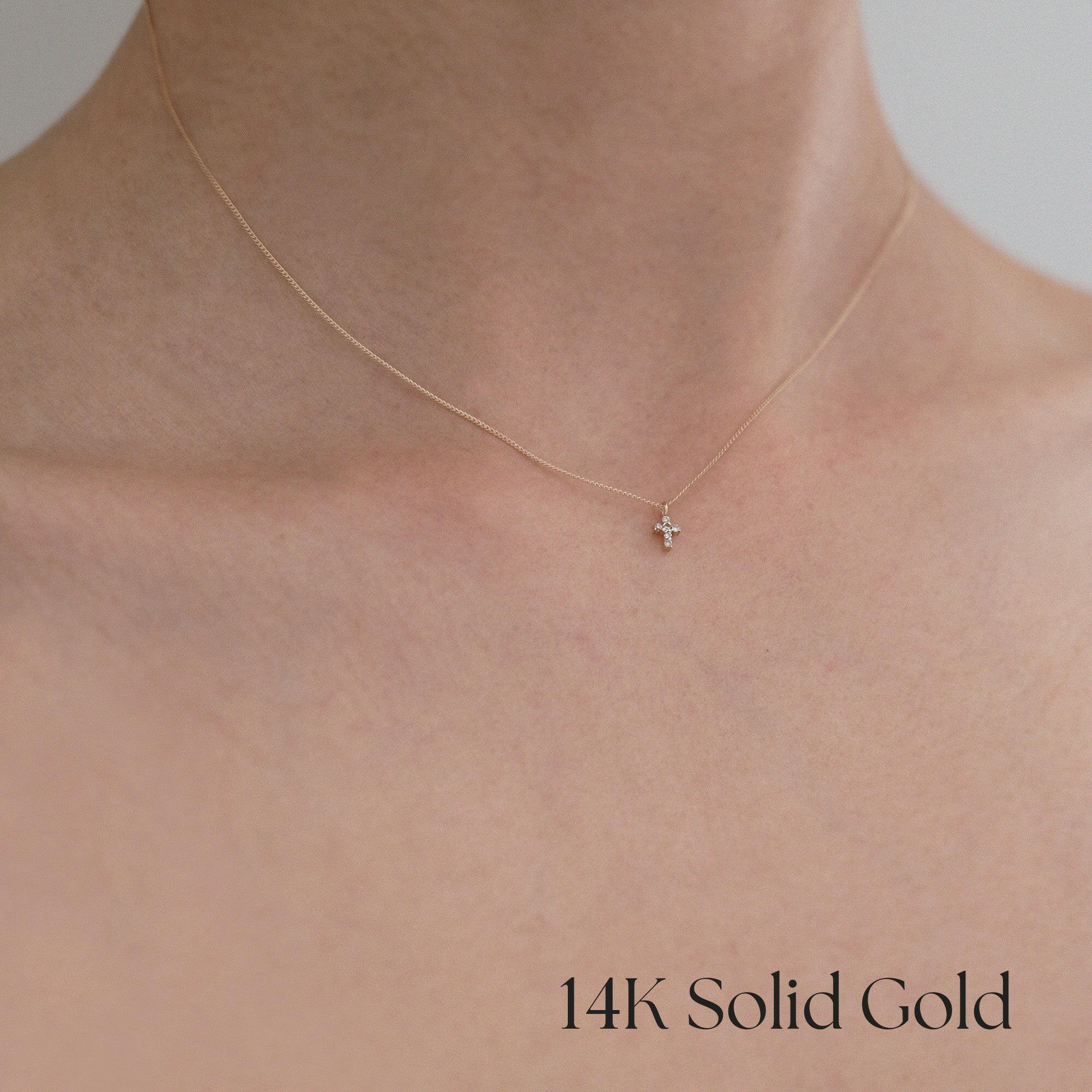 Model wearing Tiny Diamond Croce Necklace – pendant resting near collarbone