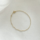 Elegant 14K gold chain bracelet with twisted design photographed from above