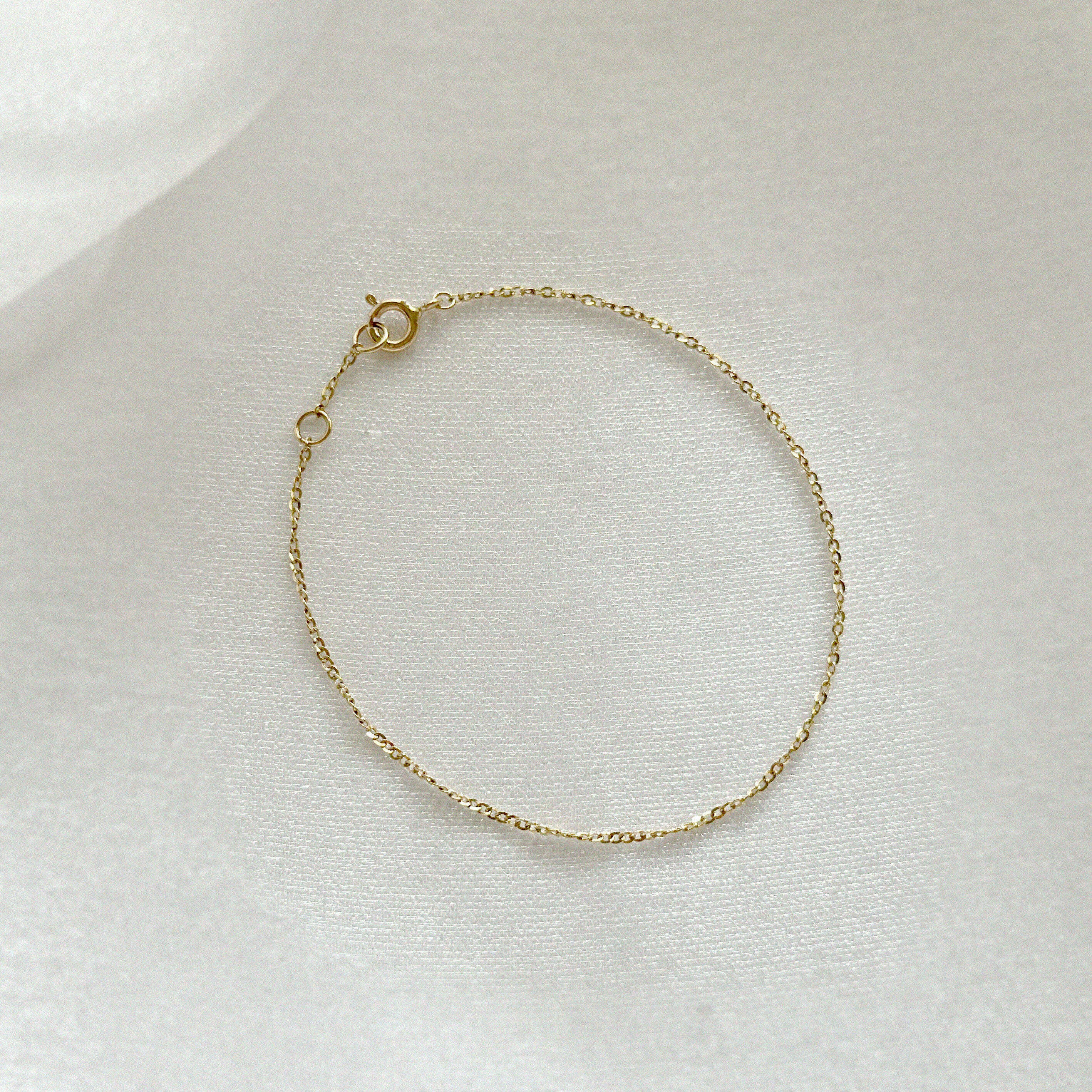 Elegant 14K gold chain bracelet with twisted design photographed from above