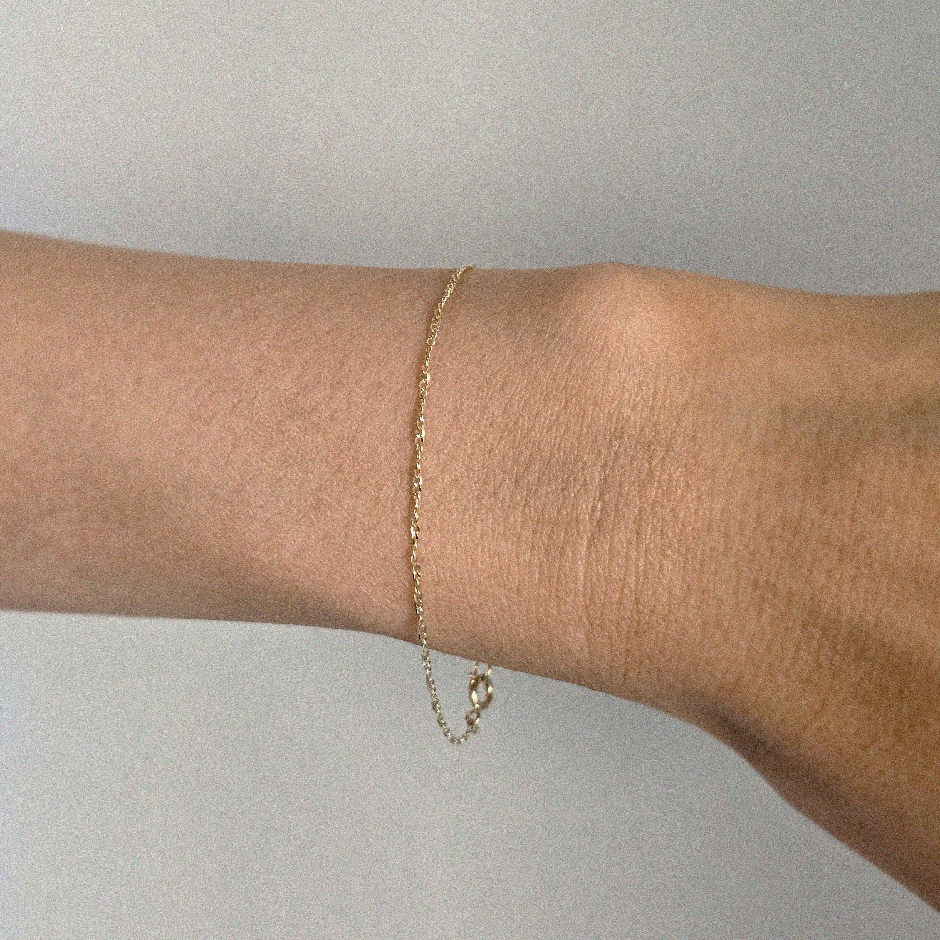 Close-up of the 14K Torino Bracelet on wrist, catching light with every movement
