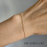 Model wearing the Torino Bracelet solo, showcasing its shimmering twisted chain on wrist