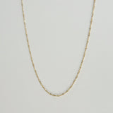 Full frontal view of the Torino Chain Necklace laid flat to display its twisted design