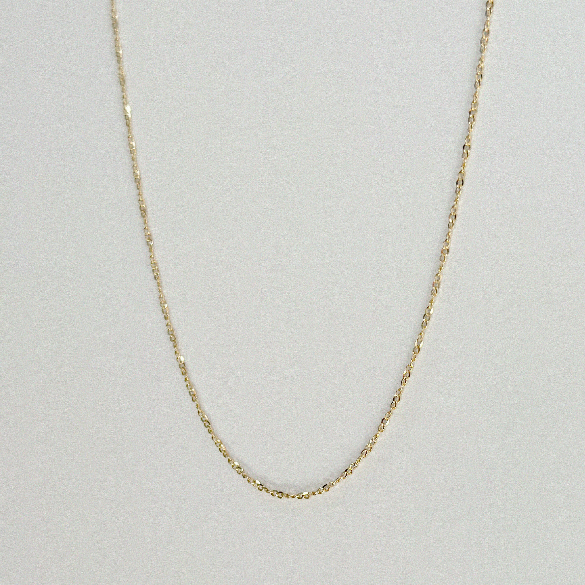 Full frontal view of the Torino Chain Necklace laid flat to display its twisted design