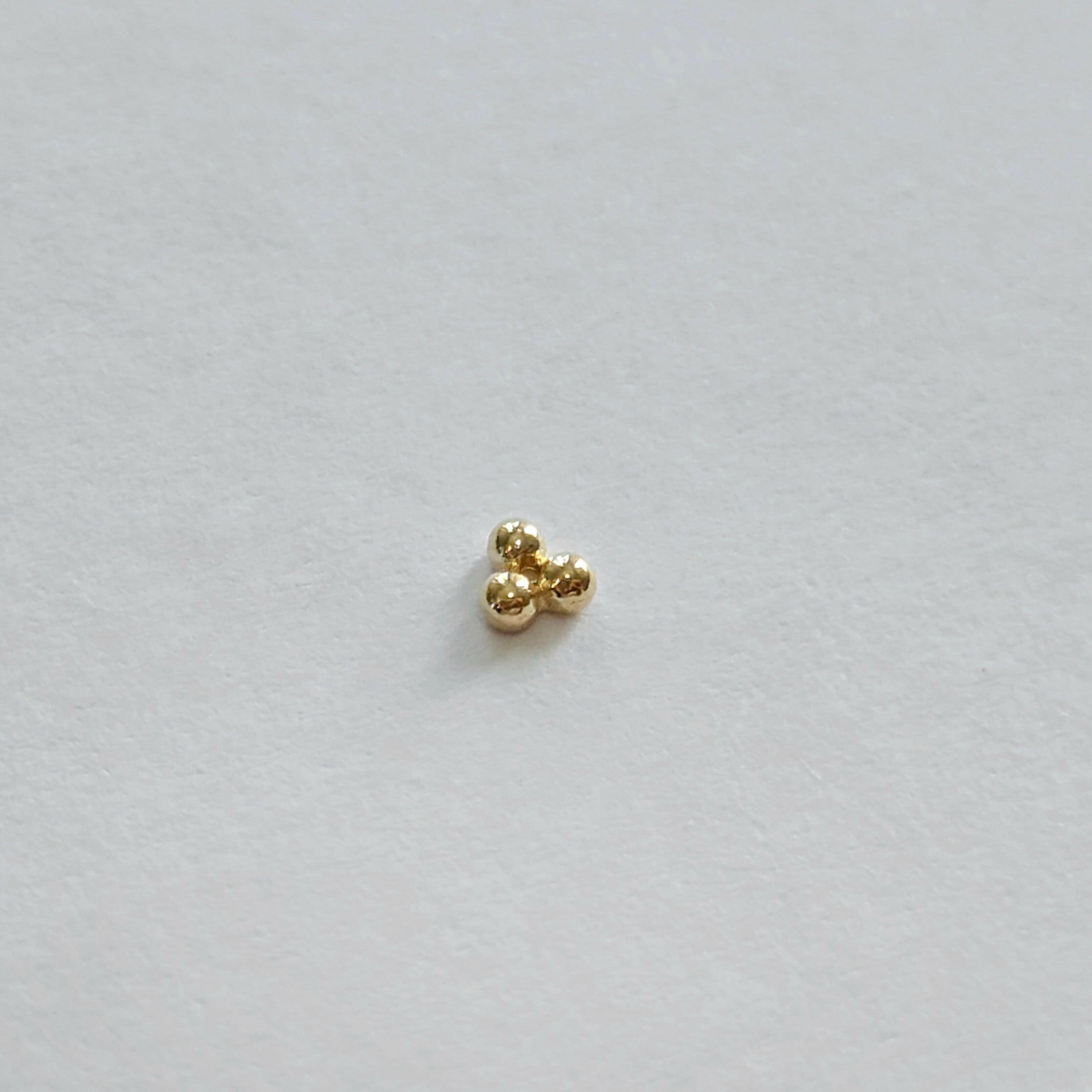 Three-ball cluster cartilage stud earring side profile photo