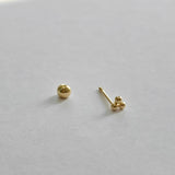 Close-up of screwball back on trio ball cartilage earring