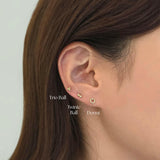 Trio ball cartilage earring stacked with other minimalist studs