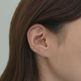 14K Donut Cartilage Earring stacked with other gold pieces