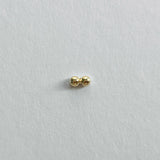 Side view of 14K gold twin ball cartilage earring on white background
