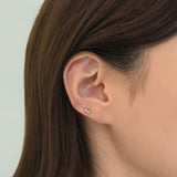 14K gold twin ball cartilage earring worn in model's ear
