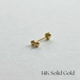 Side profile photo of 14K gold twin ball cartilage earring on white background