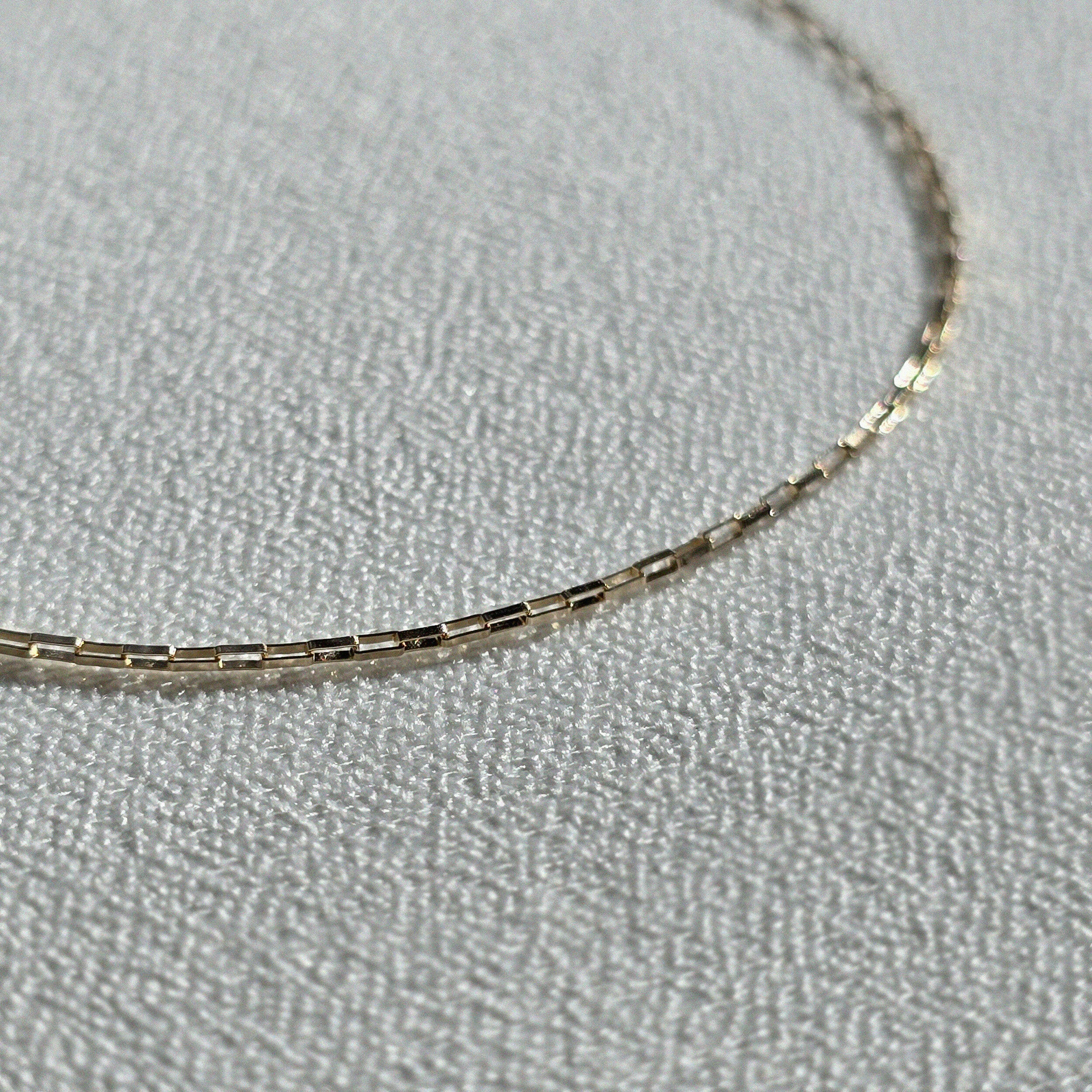 Detailed shot showing polished finish and construction of gold links