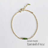 Top-down view of Gold Filled Worth II Bracelet showing centered green stones