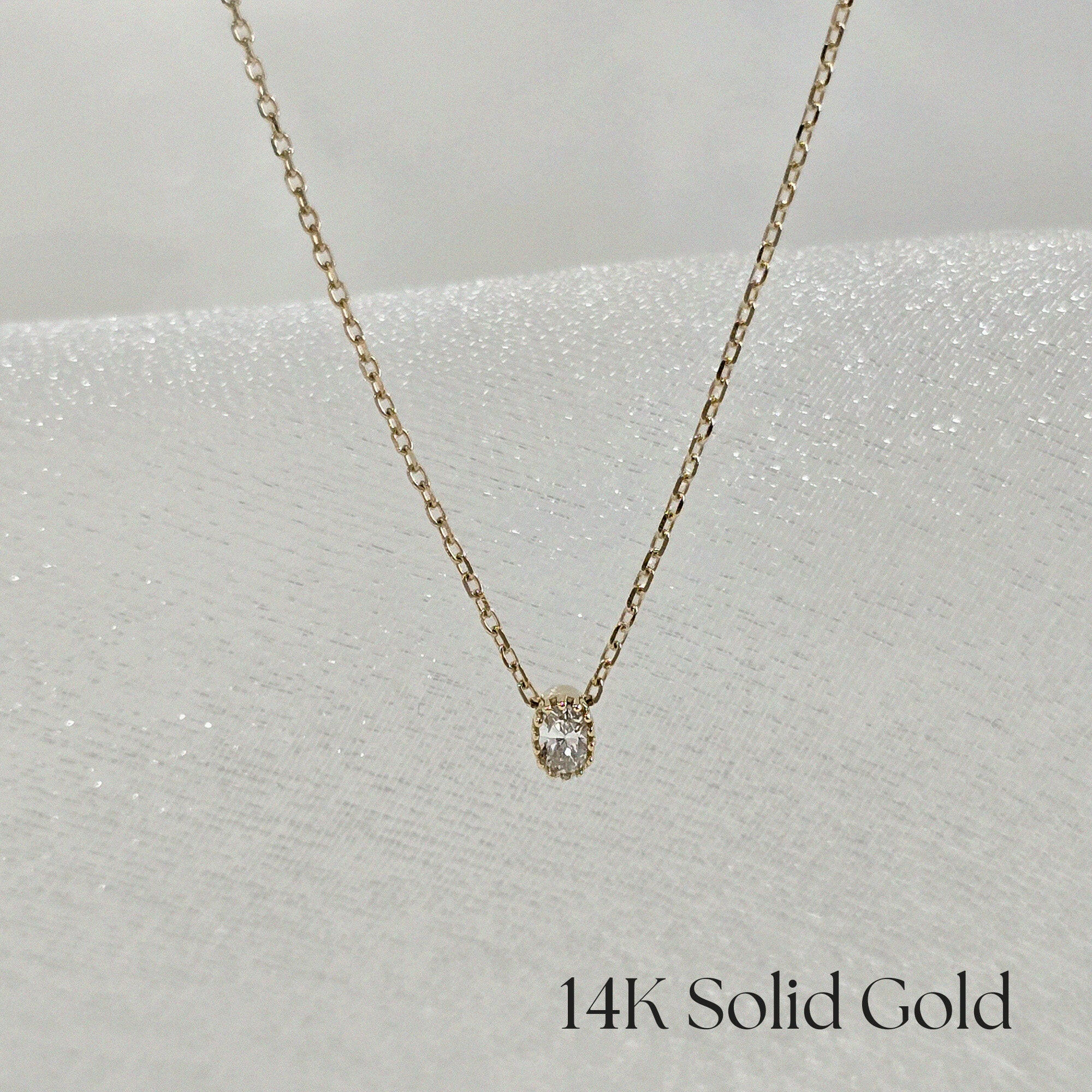 Bella Luce necklace laid flat with centered zirconia pendant – minimal elegance