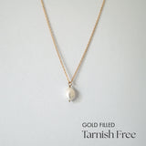 Celina Pearl Necklace laid flat with centered pearl pendant