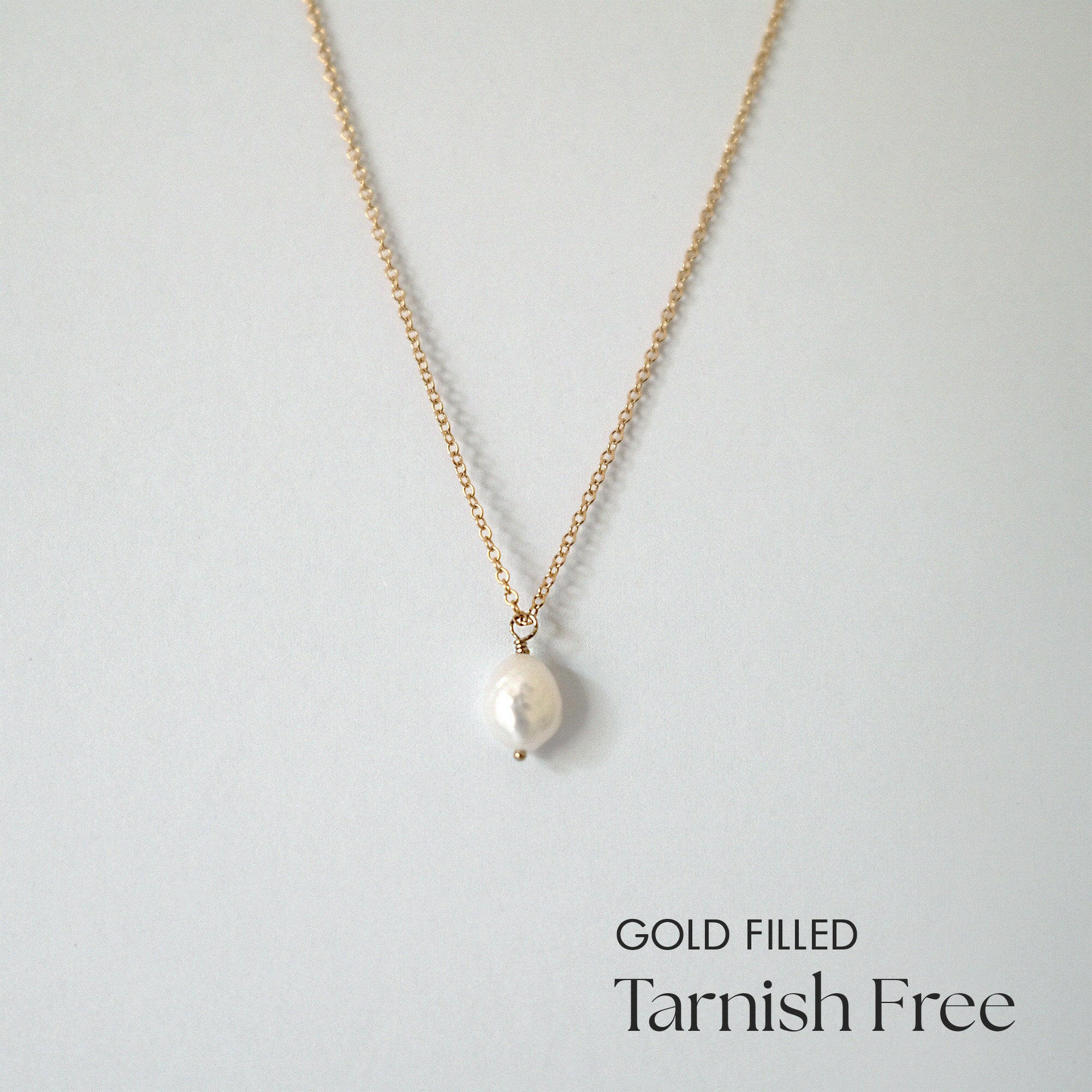 Celina Pearl Necklace laid flat with centered pearl pendant