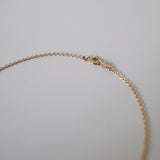 Close-up of spring ring clasp and chain connection to pearl