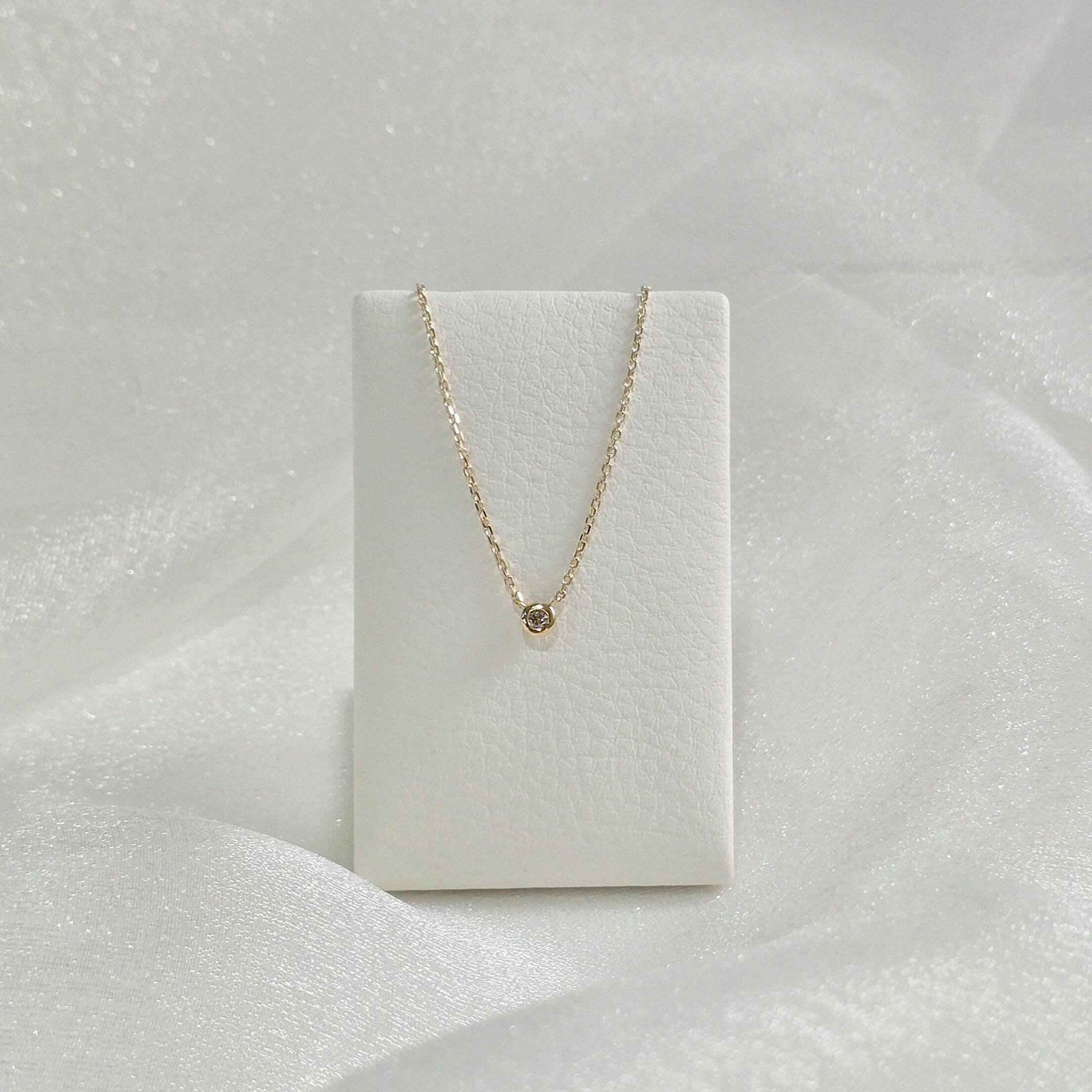 Diamond Accent Necklace presented on cream leather necklace stand – perfect drape and pendant position