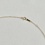 Spring ring clasp and extender detail in polished 14K gold – secure and elegant finish