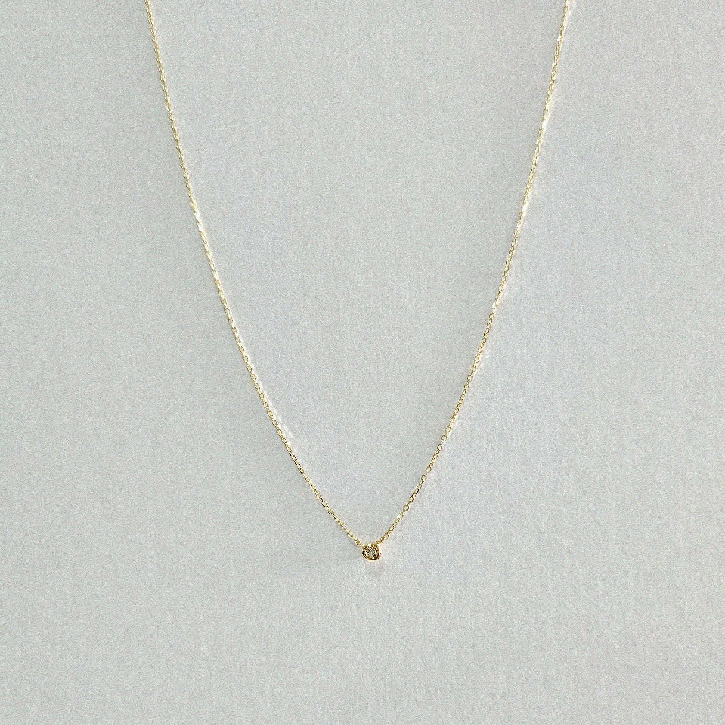 Full view of Diamond Accent Necklace with centered 4mm bezel-set diamond on fine gold chain