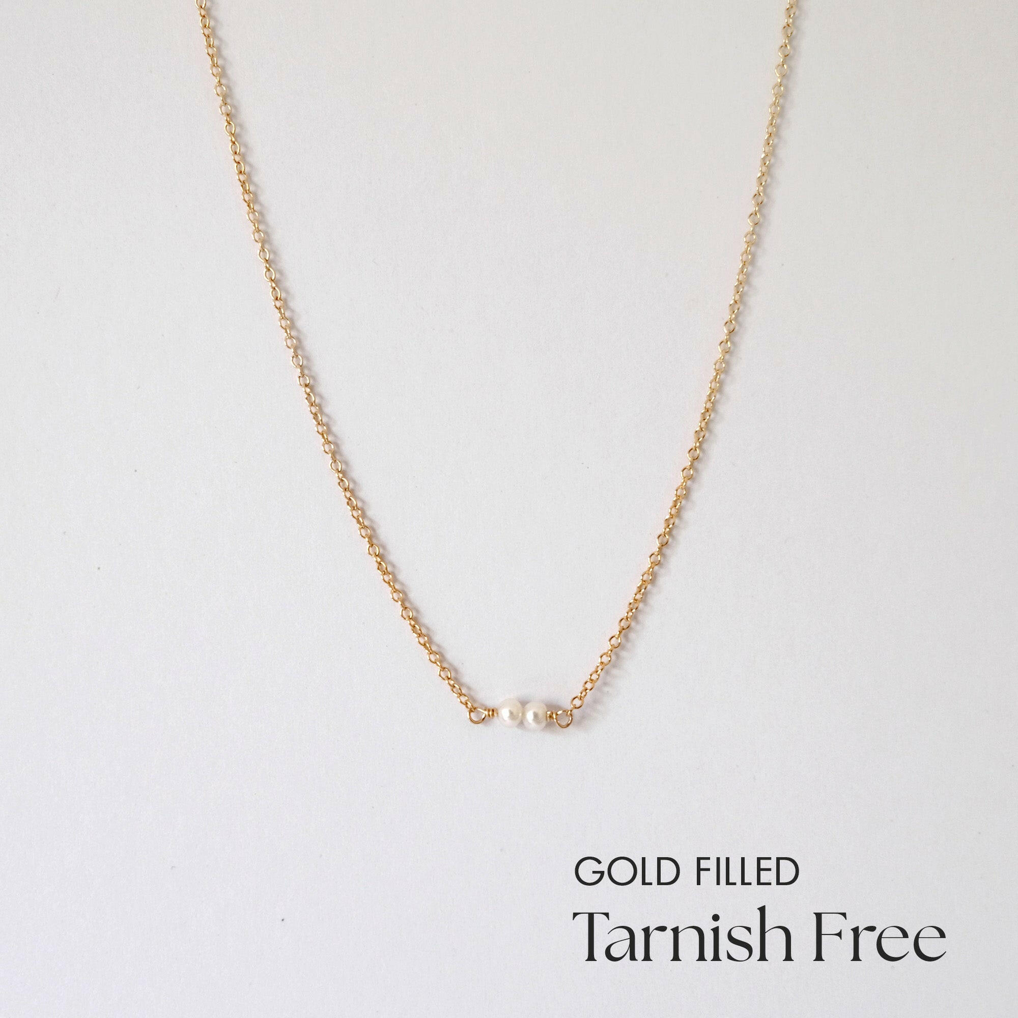 Double pearl gold filled necklace laid flat with symmetrical spacing