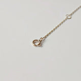 Close-up of spring ring clasp and dual O-rings on Laondrim solid gold extender chain.