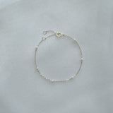 14K Ariel’s Pearl Bracelet with dainty freshwater pearls displayed on white background