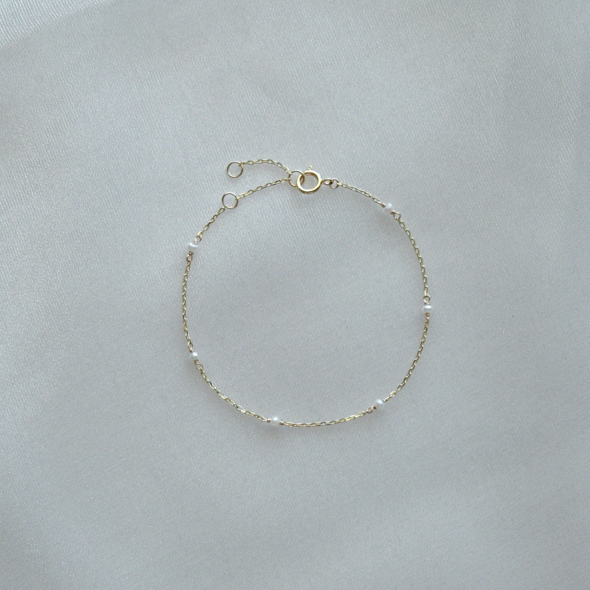 14K Ariel’s Pearl Bracelet with dainty freshwater pearls displayed on white background