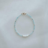 14K Gemma Beads Bracelet arranged on a beige stone tray with pearls and gemstones