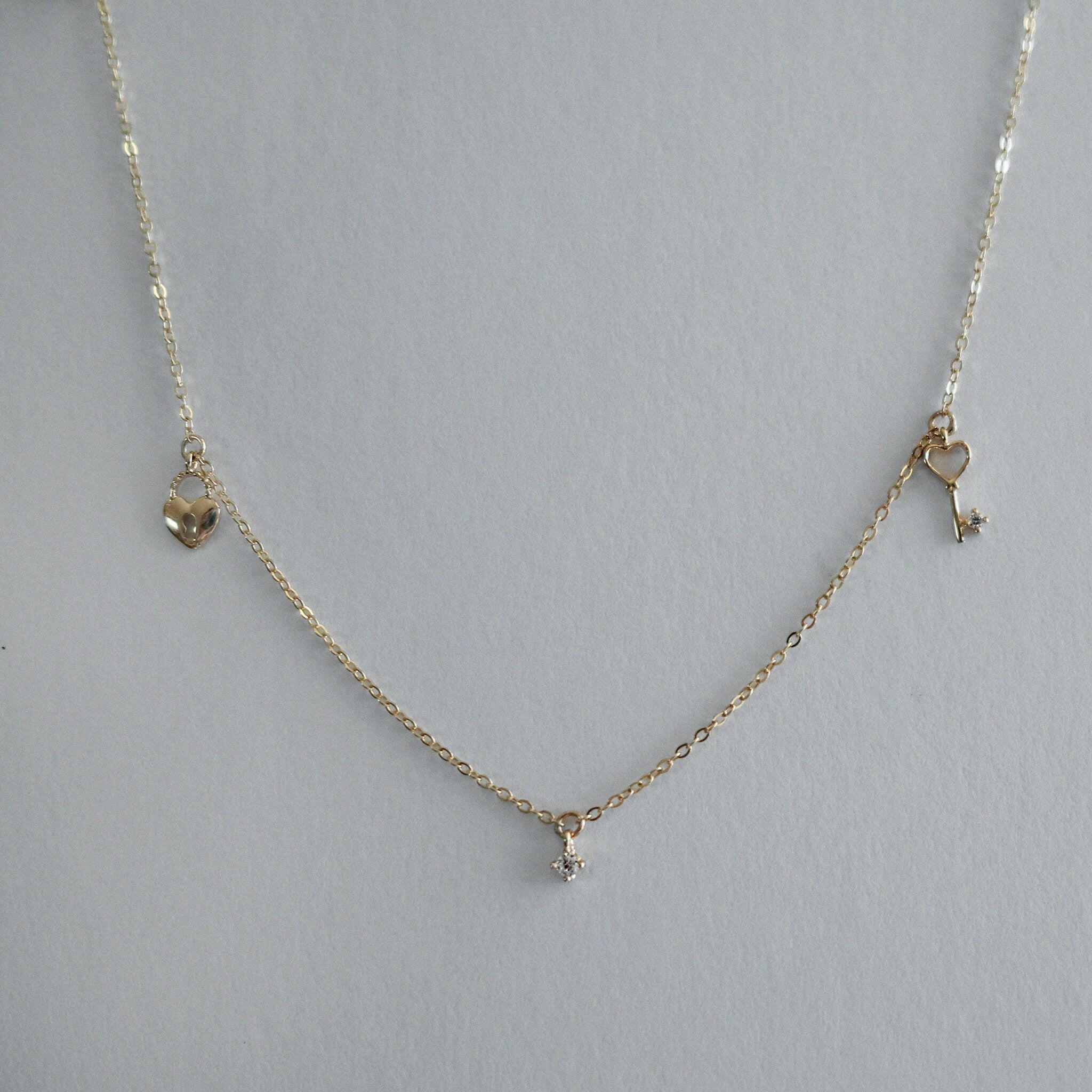 14K Solid Gold Love Is Key Necklace – Heart lock and key charm with CZ detail on adjustable chain, tarnish-free and perfect for romantic occasions