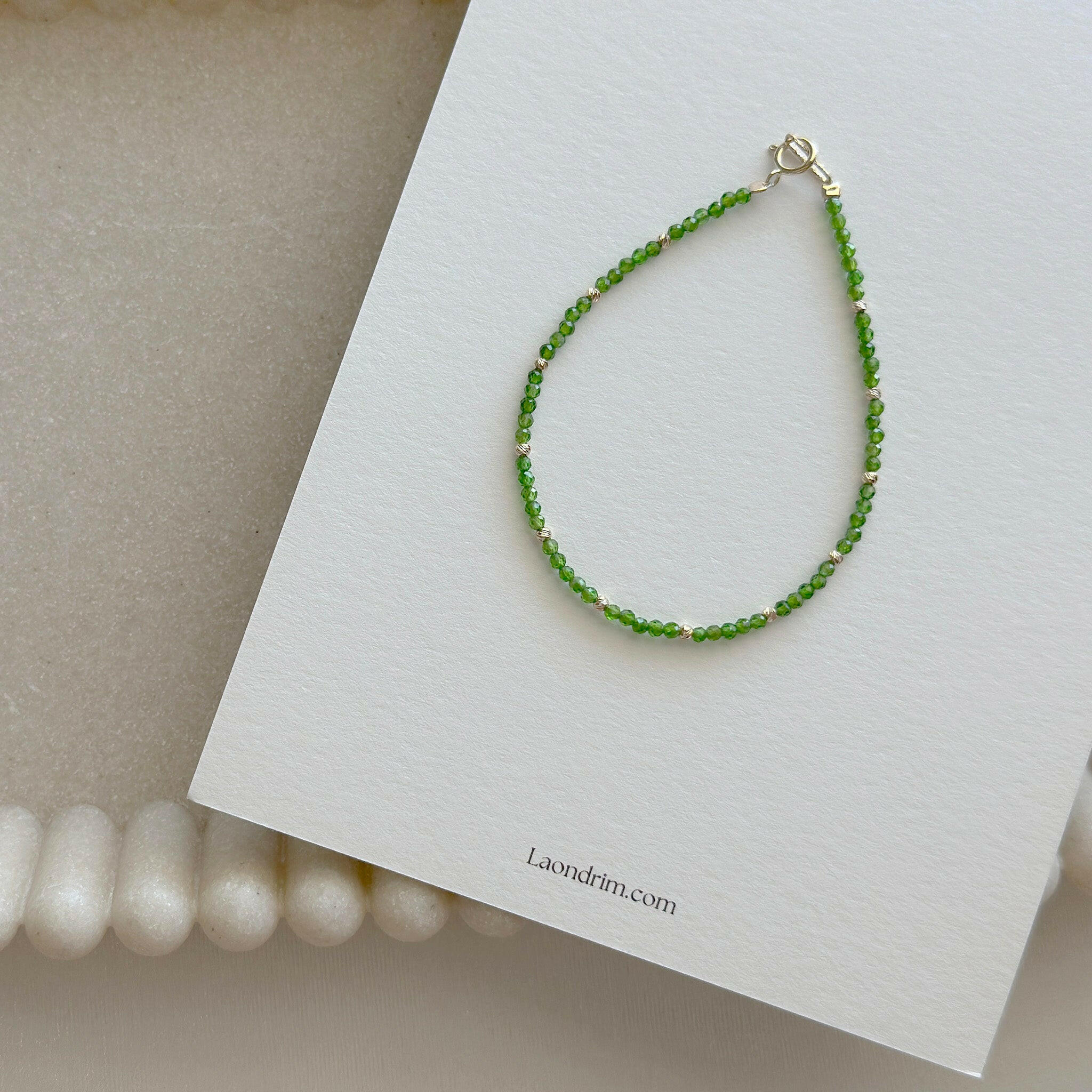 14K Prato Beads Bracelet with green diopside and gold beads displayed on branded card