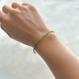 Model wearing the Prato Beads Bracelet with green gemstones on wrist