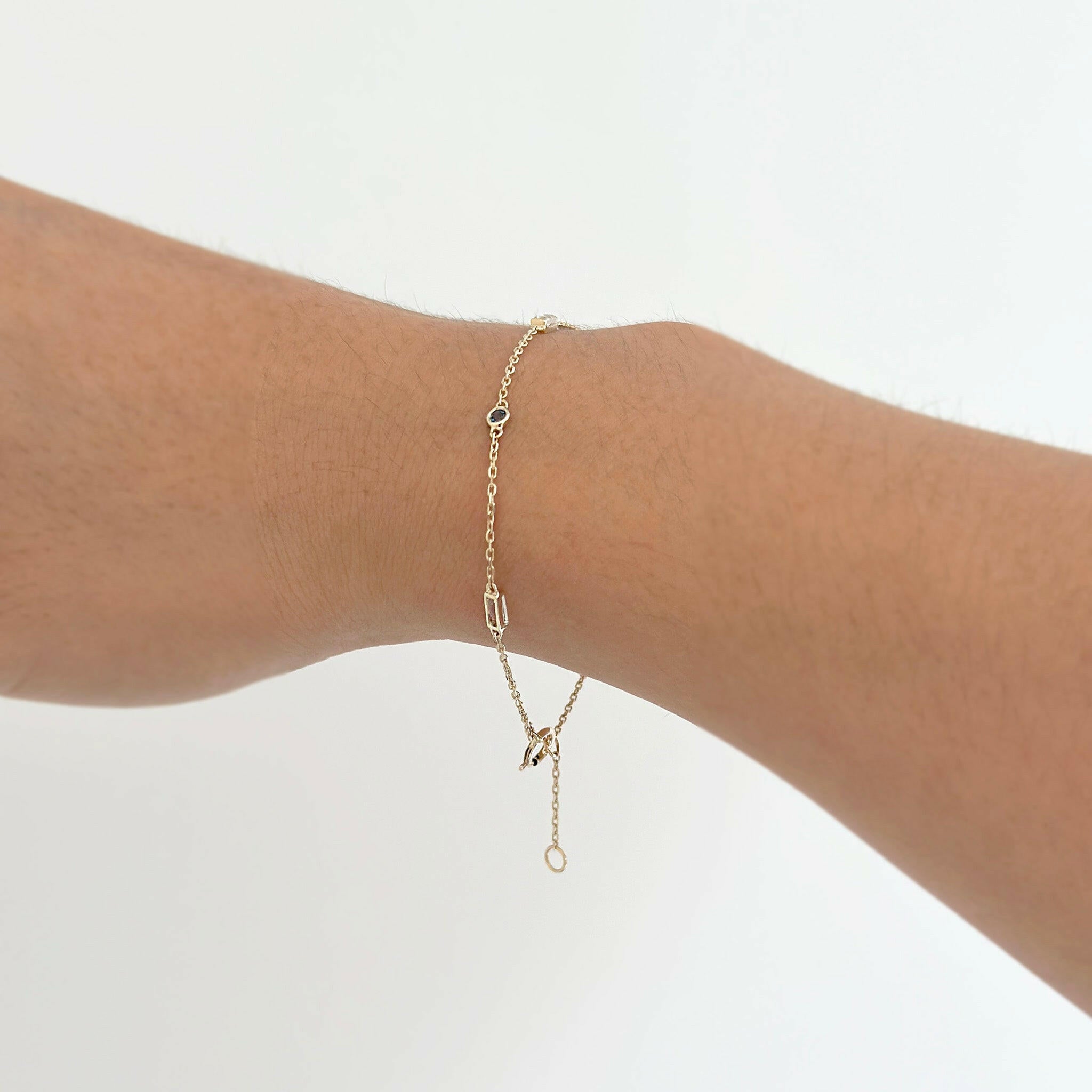 Model wearing the Rhea Stone Bracelet with Rainbow Moonstone and Blue Sapphire