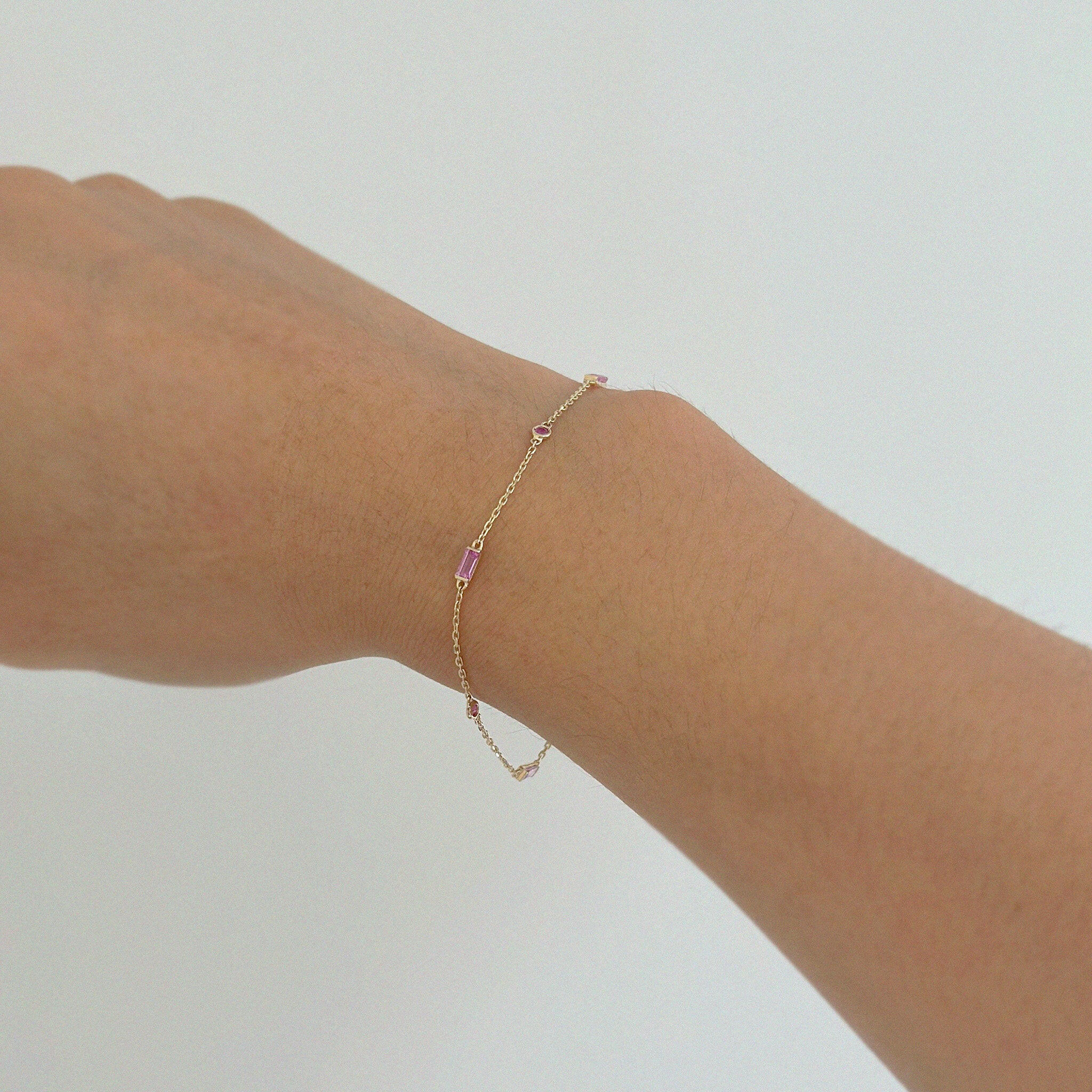 Close-up of the Rhea Bracelet with Pink Sapphire on wrist