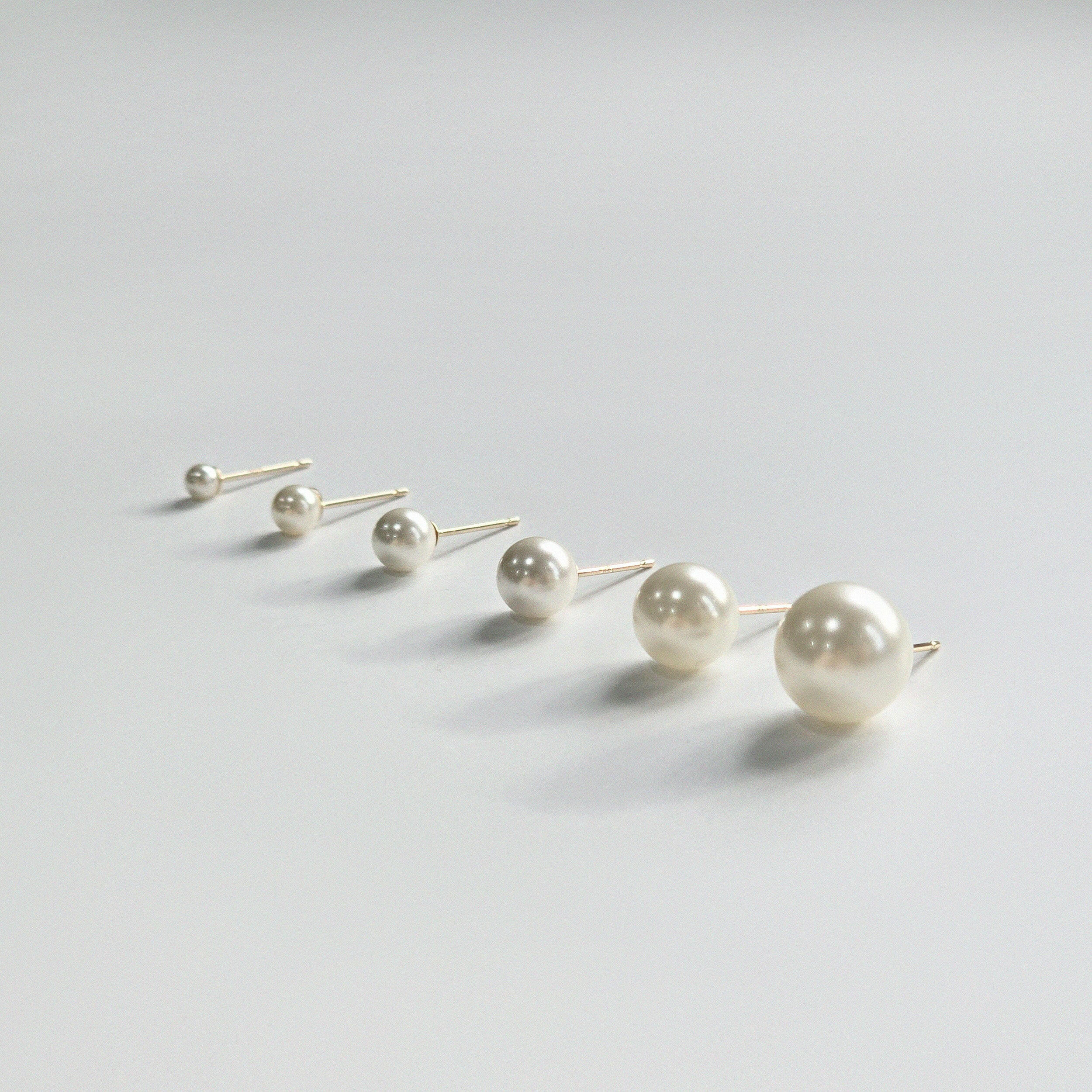 Minimalist pearl earrings viewed from the side for detail