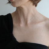 Model wearing the 14K Tiffany Chain Necklace with a black off-shoulder top, emphasizing the delicate neckline