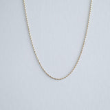 Full front view of the 14K gold twist box chain arranged in a circular form to show chain length and fluid drape