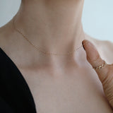 Elegant styling of the 14K gold chain worn with black outfit, showcasing its everyday versatility