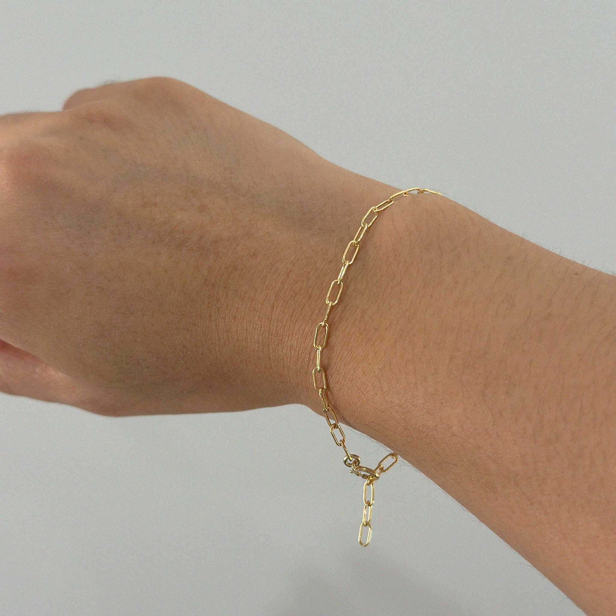 Bracelet worn on wrist viewed from above, showing link details and subtle shine