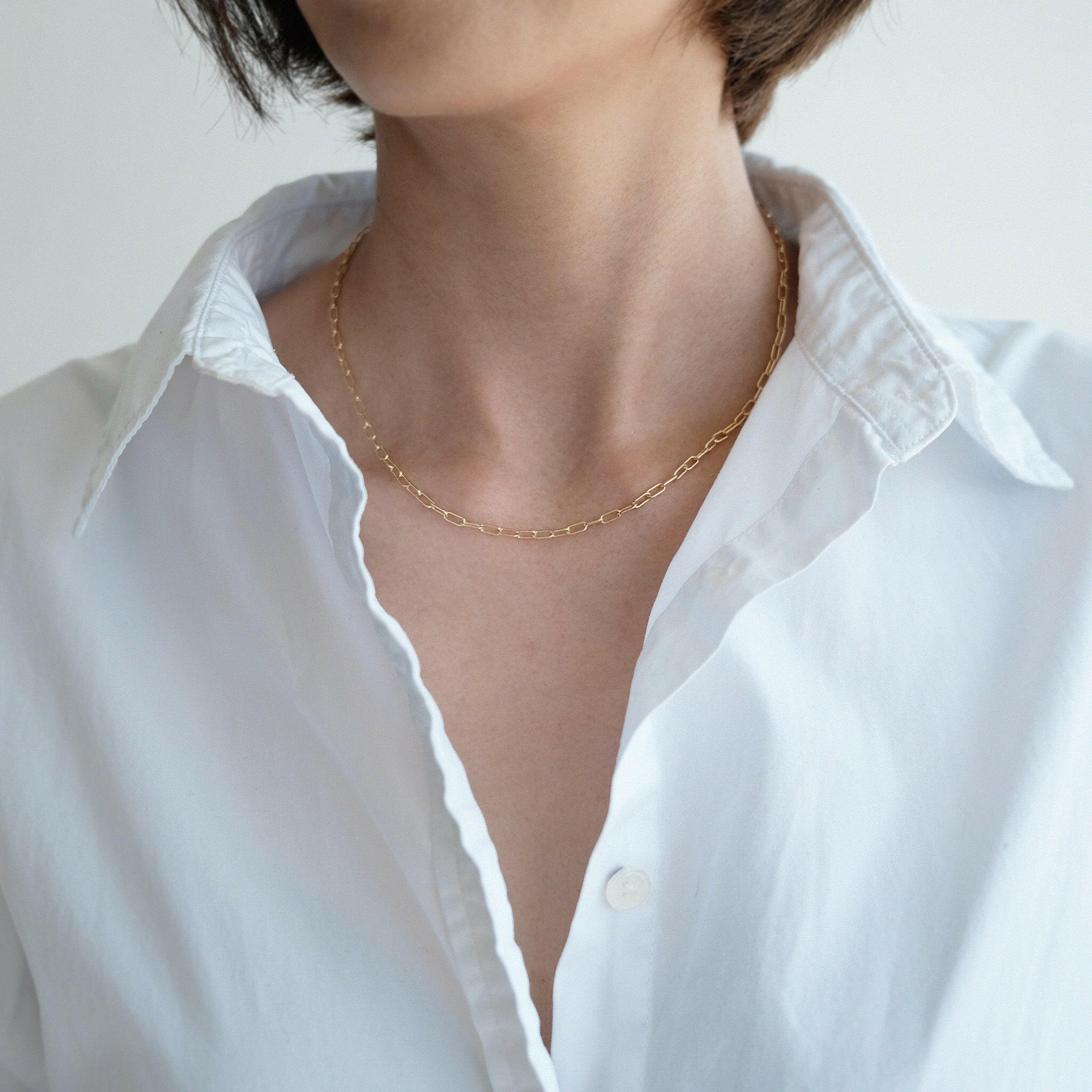 Necklace styled alone over a white shirt for a minimalist statement