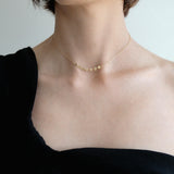 Model wearing 7 disc necklace alone with short length
