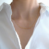 Model wearing Figaro chain necklace solo with neckline exposed