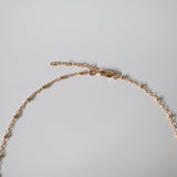 Close-up showing chain curve and polished bead texture