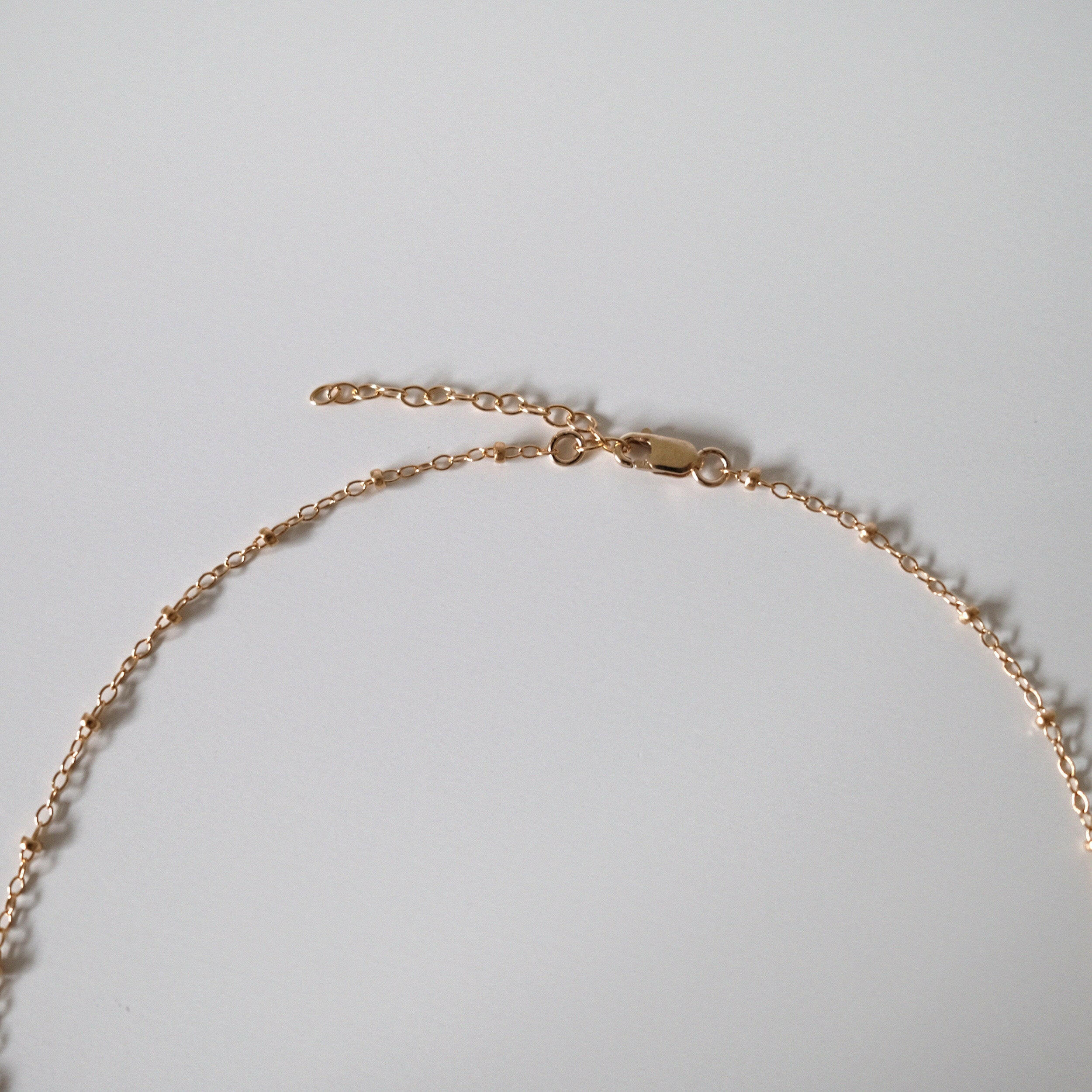 Close-up showing chain curve and polished bead texture