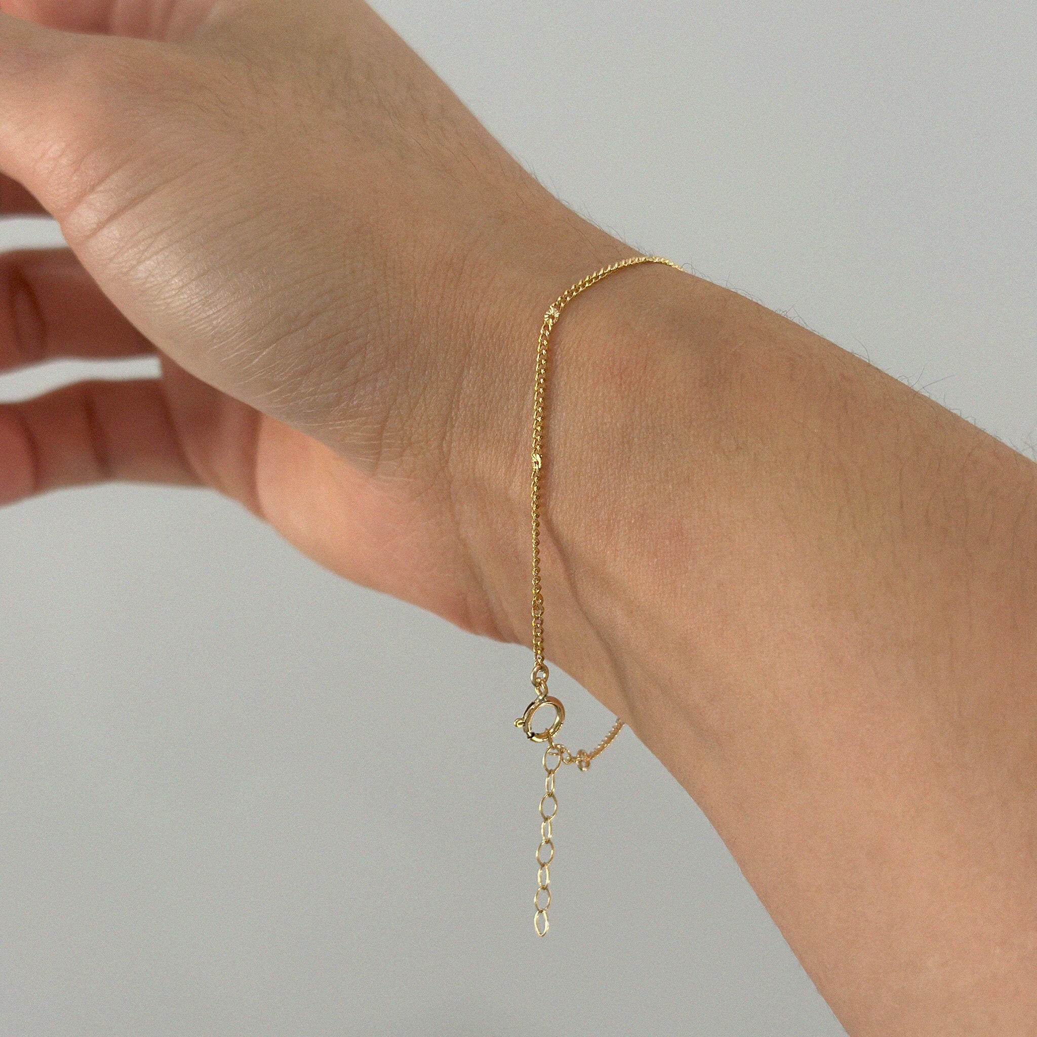 Side angle showing bracelet clasp and extended chain draping naturally