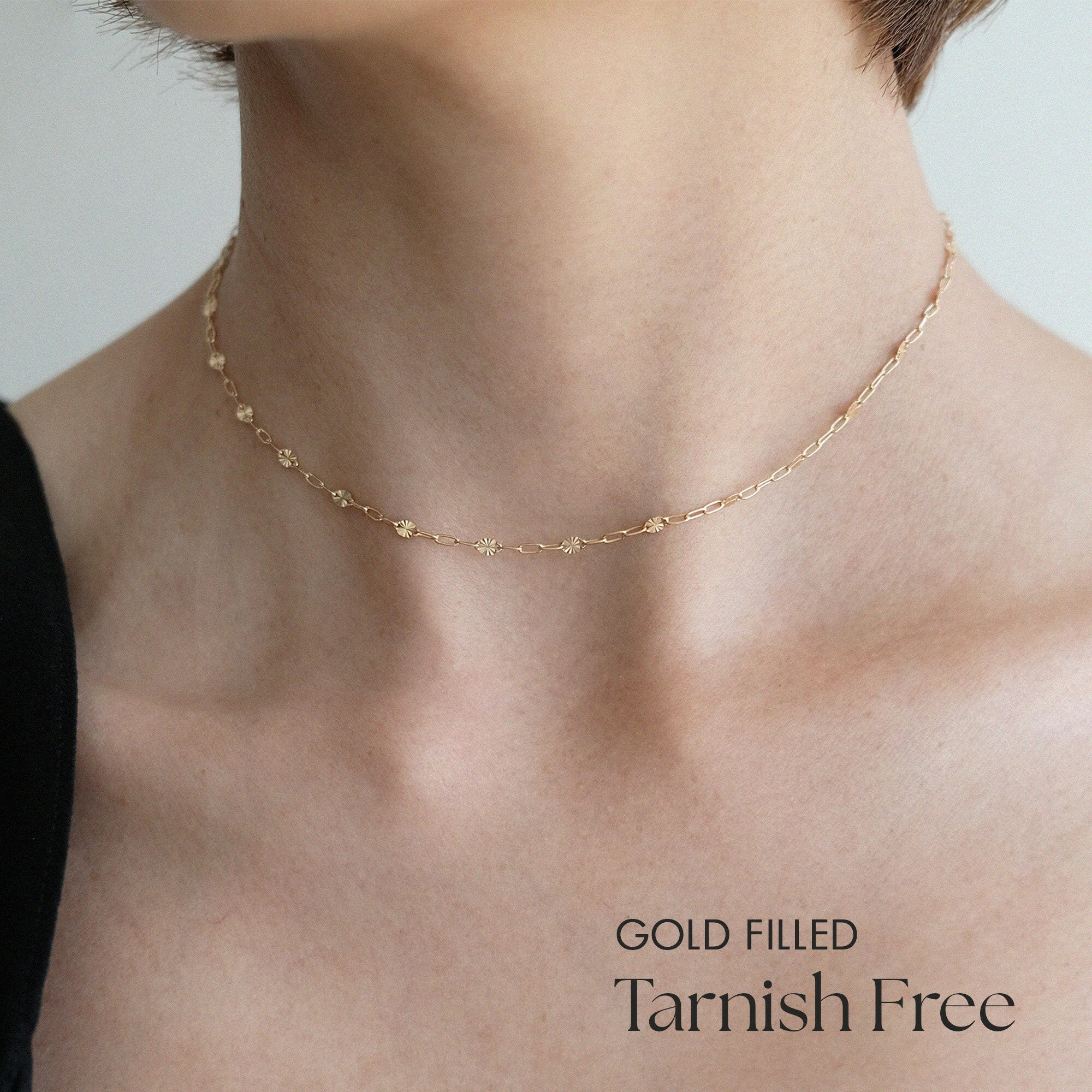 Model wearing Babel Chain alone with a minimalist neckline